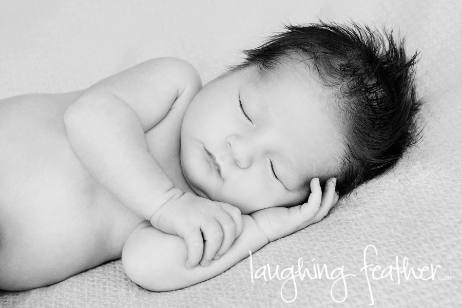 newborn sleeping on side, black and white