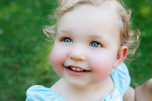 Small child looking up with blue eyes